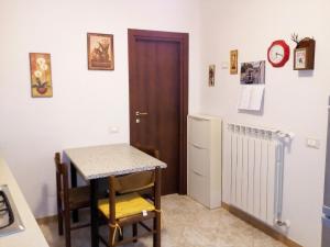 a room with a table and a small table and a refrigerator at Casa Elsa in Biassa