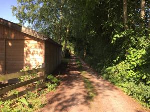 uma estrada de terra ao lado de uma cerca e árvores em Pullevaart em Elim