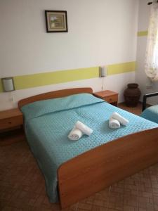 a bedroom with a bed with two towels on it at Apartment Djanina in Cres