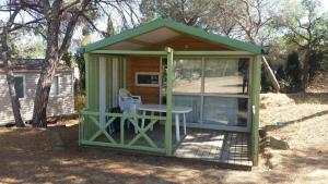 a green gazebo with a table in it at Camping la Croix du Sud in Saint-Tropez