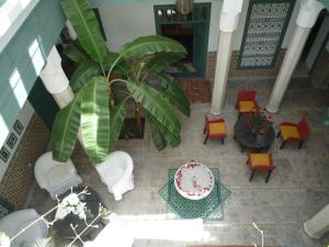 an overhead view of a living room with a table and chairs at Riad Azahar in Marrakech