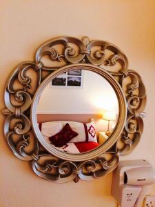 a mirror hanging on a wall in a room at Clai Ban in Kilronan