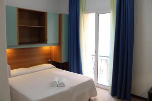 Voodi või voodid majutusasutuse Hotel Rex toas