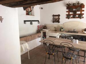 a kitchen with a table and chairs in a room at Nel Chianti lungo la Francigena in Colle di Val d'Elsa