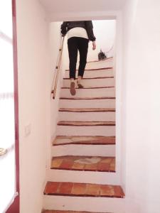 a person walking up the stairs in a house at Can Barraca in Avinyonet de Puigventós