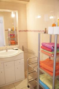 a bathroom with a sink and a mirror and towels at Arogran II in Platja d'Aro