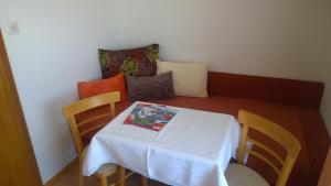 a table and chairs with a white table and pillows at Haus Ferner-Lerchner in Mariapfarr