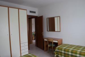 Postel nebo postele na pokoji v ubytování Residence Hotel Baia del Sole