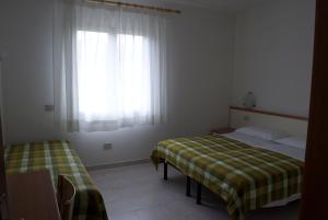 Postel nebo postele na pokoji v ubytování Residence Hotel Baia del Sole