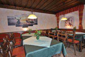 a dining room with two tables and chairs at Pension Sybille in Ebensee