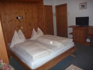 1 Schlafzimmer mit 2 Betten und weißer Bettwäsche in der Unterkunft Haus Bellis in Neustift im Stubaital