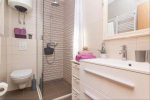 a bathroom with a shower and a toilet and a sink at Apartments Garmaz in Podgora