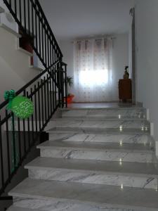 a stairway with a light shining through a window at Casa Vacanze Isabella in Aliano +49 photos