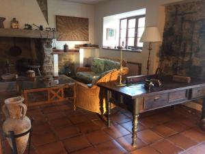 a living room with a table and a fireplace at Casa Firmo in Quintana