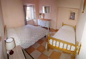 a bedroom with two beds and a dresser and a window at Apartments Mia in Dubrovnik