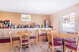 a restaurant with tables and chairs and a counter at Days Inn by Wyndham Augusta Wheeler Road in Augusta