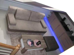 a living room with a couch and a table at Apartament Monika Rewal z widokiem na morze in Rewal