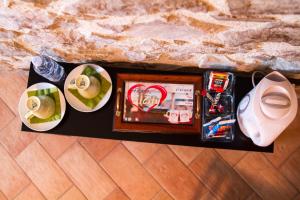 a tray with a picture and plates of food on it at Heart Of Sicily in Mistretta