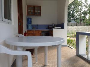 a white table and chairs in a kitchen at Mangoes Place in Moalboal