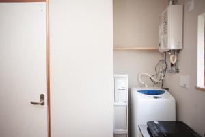 a small kitchen with a refrigerator and a microwave at Ninja TABI-NE in Kanazawa