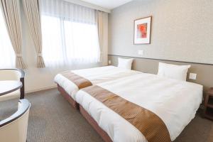 Un pat sau paturi într-o cameră la Hotel Amabile Maizuru
