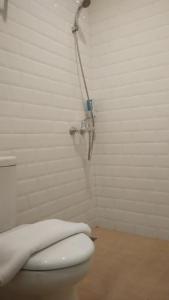 a bathroom with a shower with a toilet in it at DOM Hotel Jogja in Yogyakarta