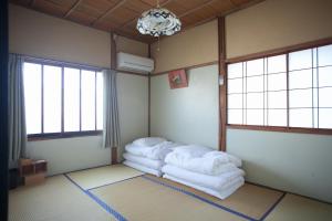 Postel nebo postele na pokoji v ubytování Kanazawa TABI-NE