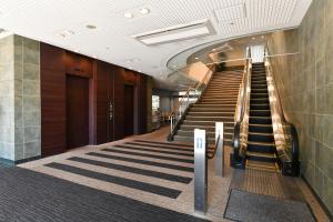 a stairway in a building with a escalator at Richmond Hotel Hamamatsu in Hamamatsu