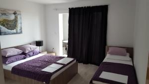 Posteľ alebo postele v izbe v ubytovaní apartmani mihaljević