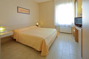 a bedroom with a bed and a window and a television at Hotel Mary in La Spezia