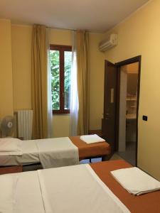 Postel nebo postele na pokoji v ubytování Hotel Greco