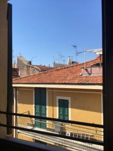 a view from a window of a building with green doors at Al Castello Affittacamere in Pietra Ligure