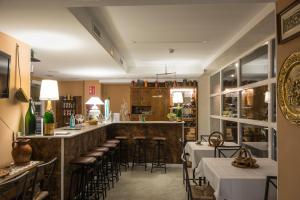 a restaurant with tables and chairs and a bar at Hotel Boutique Casona del Boticario in San Vicente de la Sonsierra