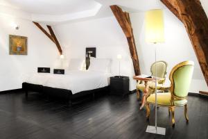 a bedroom with a bed and a table and chairs at Château Les Merles et ses Villas in Mouleydier +90 photos