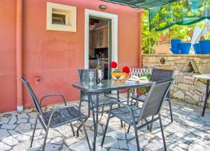 a table and chairs sitting on a patio at Nandia Studio & Apartment in Gaios