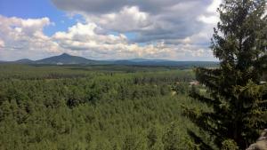 an aerial view of a forest with mountains in the background at Ralsko-Hradcany - apartmán in Hradčany +10 photos