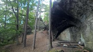 a cave in the side of a rock in a forest at Ralsko-Hradcany - apartmán in Hradčany