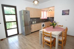 a kitchen with a table with chairs and a refrigerator at Salakos Mountain View Home in Sálakos