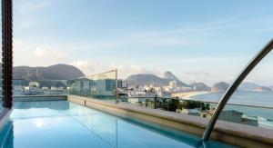 a swimming pool with a view of the ocean at Ritz Copacabana Boutique Hotel in Rio de Janeiro