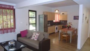 a living room with a couch and a table and a kitchen at Mountain view Holiday in Salakos, Rhodes in Sálakos