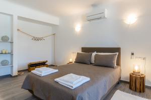 a bedroom with a bed with two towels on it at Eleni's Village Suites in Klouvas