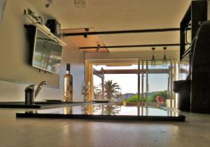 a kitchen with a counter with a view of a pool at Apartment Naturist Cap In Loft in Cap d'Agde