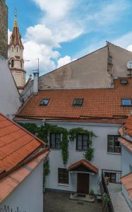 a view of the roofs of a building with a tower at Baron's Arthouse Apartment in Vilnius +10 photos