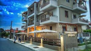 a building with people walking in front of it at Mediterranean Holidays in Ierissos