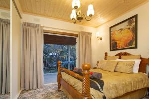 a bedroom with a bed and a large window at Hahndorf House B&B in Hahndorf +101 photos