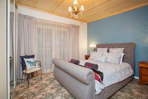 a bedroom with a bed and a couch in it at Hahndorf House B&B in Hahndorf