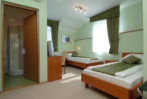 a hotel room with two beds and a bathroom at Hotel Varazdin in Varaždin +43 photos