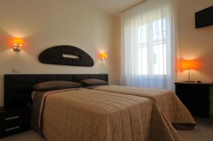 a bedroom with a bed and a large window at B&B Il Grifone in Pistoia