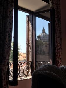 a bedroom window with a view of a building at Catherine's Home in Rome