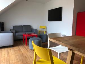 a living room with a couch and a table and chairs at SWISS LOFT by Europa-Park - EP Ticket Garantie in Rust